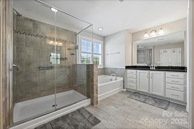 10906 Angler Ct, Davidson, NC 28036 - bathroom featuring a bath, vanity, a shower stall, and tile patterned flooring