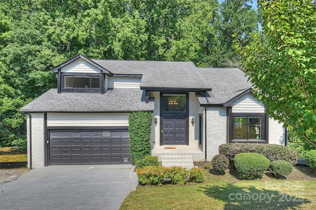 9334 Hunting Ct, Matthews, NC 28105 - view of front of home featuring driveway, a shingled roof, brick siding, a garage, and a front lawn