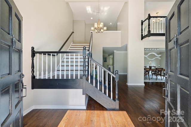 9334 Hunting Ct, Matthews, NC 28105 - foyer featuring a chandelier, wood finished floors, a high ceiling, and stairway