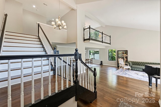 9334 Hunting Ct, Matthews, NC 28105 - stairway featuring high vaulted ceiling, beam ceiling, a chandelier, and wood finished floors