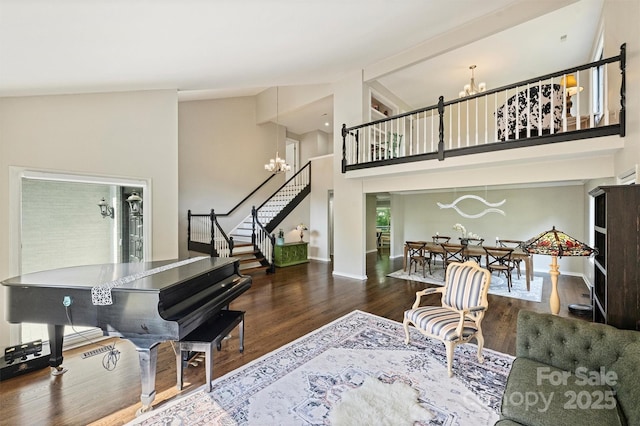 9334 Hunting Ct, Matthews, NC 28105 - living area featuring a chandelier, stairs, high vaulted ceiling, and wood finished floors