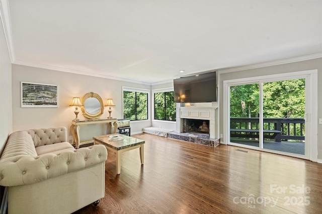 9334 Hunting Ct, Matthews, NC 28105 - living room featuring crown molding, wood finished floors, and a fireplace with raised hearth