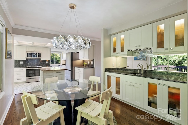 9334 Hunting Ct, Matthews, NC 28105 - dining room with crown molding, dark wood-type flooring, and a chandelier