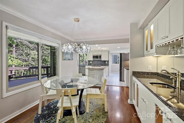 9334 Hunting Ct, Matthews, NC 28105 - dining room featuring dark wood-style floors and ornamental molding