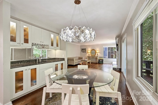 9334 Hunting Ct, Matthews, NC 28105 - dining space featuring ornamental molding, dark wood-type flooring, and a chandelier