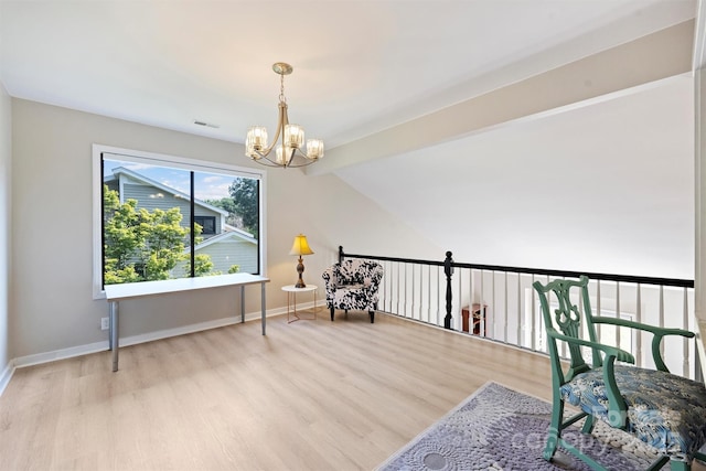 9334 Hunting Ct, Matthews, NC 28105 - sitting room with wood finished floors, a chandelier, and vaulted ceiling