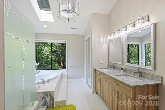 9334 Hunting Ct, Matthews, NC 28105 - bathroom featuring a skylight, double vanity, a bath, lofted ceiling, and a chandelier
