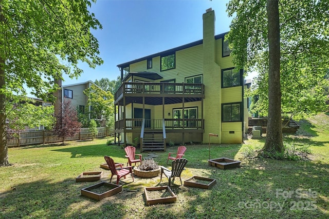 9334 Hunting Ct, Matthews, NC 28105 - rear view of house with crawl space, an outdoor fire pit, a garden, and a deck