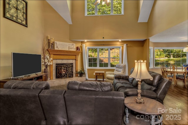 59 Old Lakey Gap Rd, Black Mountain, NC 28711 - living room with wood finished floors, a tile fireplace, healthy amount of natural light, and a high ceiling