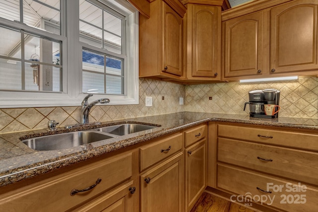 59 Old Lakey Gap Rd, Black Mountain, NC 28711 - kitchen featuring dark stone counters, backsplash, brown cabinetry, and wood finished floors