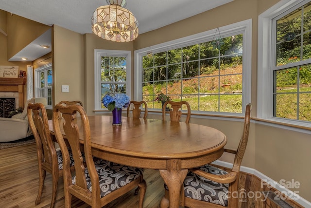 59 Old Lakey Gap Rd, Black Mountain, NC 28711 - dining room with a chandelier, wood finished floors, and a tiled fireplace