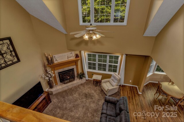 59 Old Lakey Gap Rd, Black Mountain, NC 28711 - living area with a tile fireplace, a towering ceiling, ceiling fan, and wood finished floors