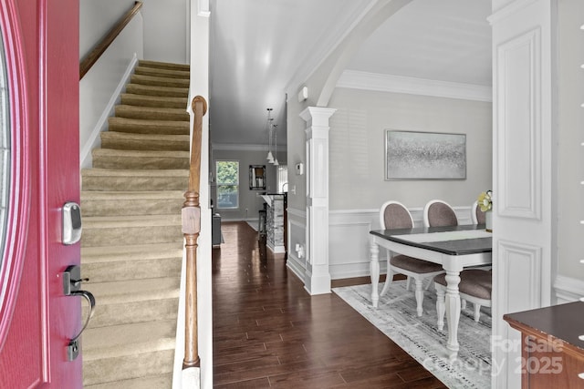 10621 Shanon Darby Ln, Charlotte, NC 28214 - entryway with ornamental molding, arched walkways, stairway, wood finished floors, and a wainscoted wall