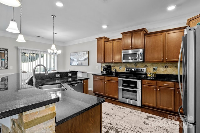 10621 Shanon Darby Ln, Charlotte, NC 28214 - kitchen with appliances with stainless steel finishes, ornamental molding, wood finished floors, a chandelier, and brown cabinets