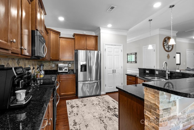 10621 Shanon Darby Ln, Charlotte, NC 28214 - kitchen with stainless steel appliances, brown cabinetry, ornamental molding, dark wood-type flooring, and backsplash