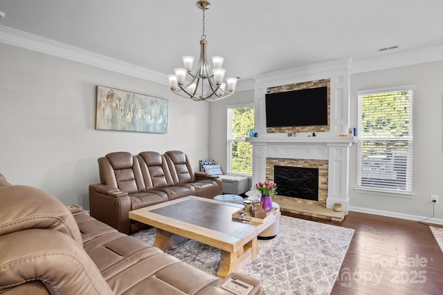 10621 Shanon Darby Ln, Charlotte, NC 28214 - living area featuring ornamental molding, a chandelier, dark wood-type flooring, and a stone fireplace