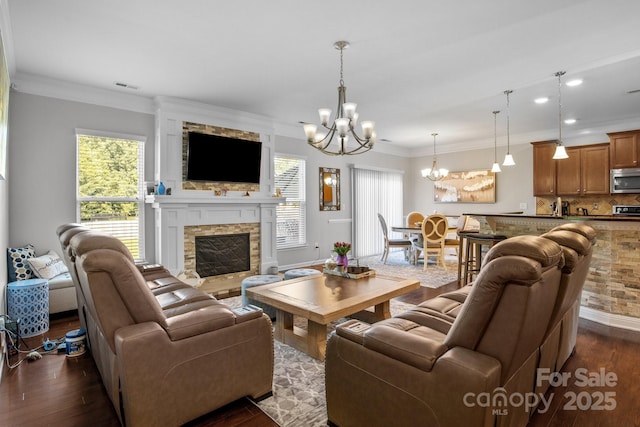 10621 Shanon Darby Ln, Charlotte, NC 28214 - living area with a chandelier, healthy amount of natural light, dark wood-type flooring, a fireplace, and crown molding