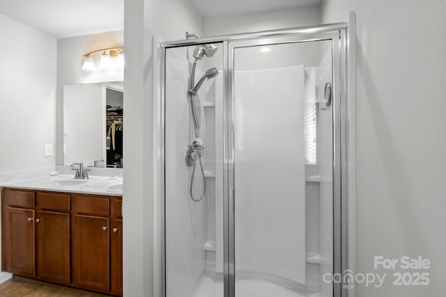 10621 Shanon Darby Ln, Charlotte, NC 28214 - bathroom with a shower stall, double vanity, and a walk in closet