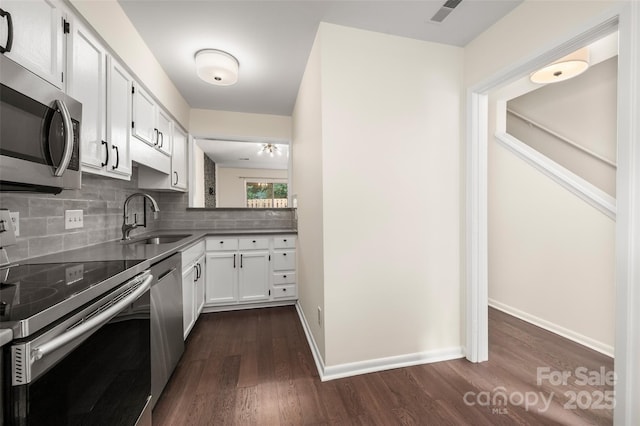 6013 Heath Valley Rd, Charlotte, NC 28210 - kitchen with stainless steel appliances, dark wood-style floors, decorative backsplash, and white cabinets