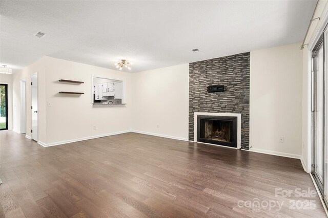 6013 Heath Valley Rd, Charlotte, NC 28210 - unfurnished living room featuring dark wood-style flooring and a tiled fireplace