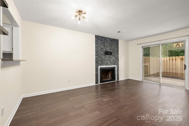 6013 Heath Valley Rd, Charlotte, NC 28210 - unfurnished living room with a textured ceiling, dark wood finished floors, and a large fireplace