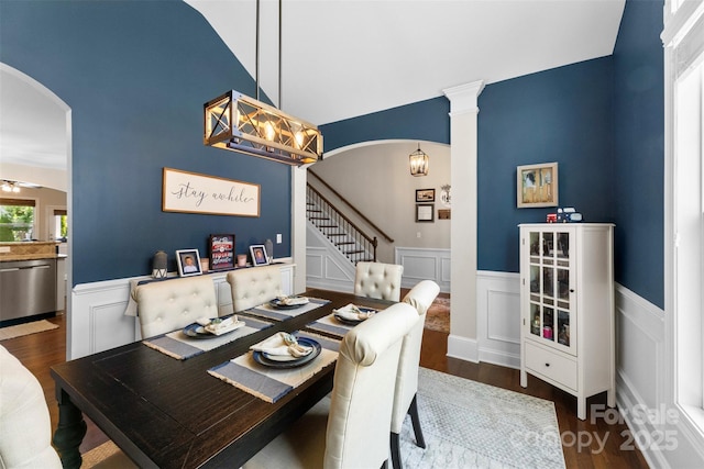 116 Kentmere Ln, Clover, SC 29710 - dining area featuring arched walkways, wood finished floors, wainscoting, stairs, and a decorative wall
