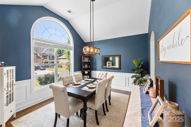116 Kentmere Ln, Clover, SC 29710 - dining area featuring wood finished floors, vaulted ceiling, wainscoting, a chandelier, and a decorative wall