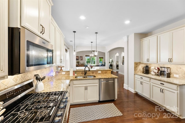 116 Kentmere Ln, Clover, SC 29710 - kitchen featuring stainless steel appliances, arched walkways, a peninsula, tasteful backsplash, and pendant lighting