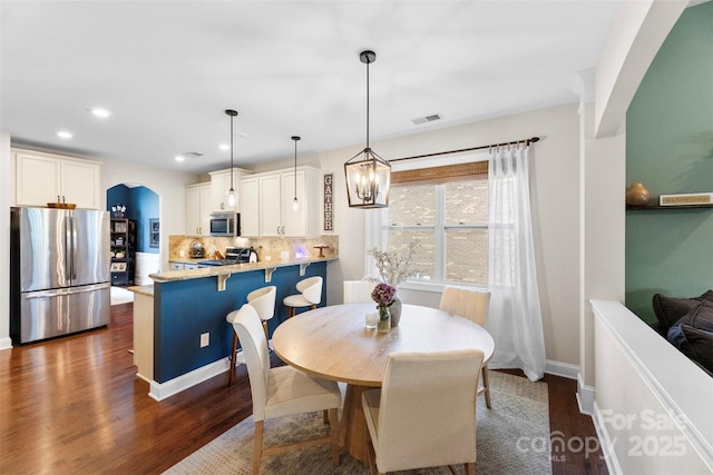 116 Kentmere Ln, Clover, SC 29710 - dining area featuring arched walkways, recessed lighting, dark wood finished floors, and a chandelier