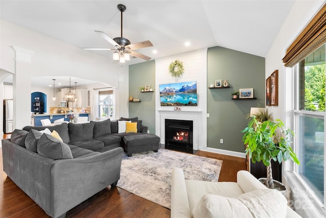 116 Kentmere Ln, Clover, SC 29710 - living room featuring arched walkways, a fireplace with flush hearth, dark wood finished floors, vaulted ceiling, and a ceiling fan