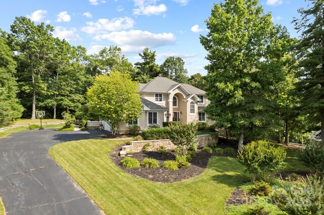 117 Founders Dr, Flat Rock, NC 28731 - view of front facade with driveway, a front lawn, and stucco siding