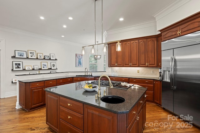 117 Founders Dr, Flat Rock, NC 28731 - kitchen with appliances with stainless steel finishes, a kitchen island with sink, ornamental molding, wood finished floors, and dark stone countertops