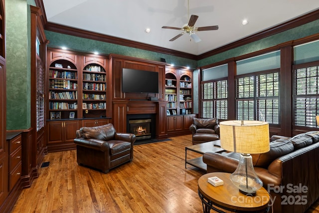 117 Founders Dr, Flat Rock, NC 28731 - living area featuring a ceiling fan, crown molding, a fireplace with flush hearth, and light wood finished floors