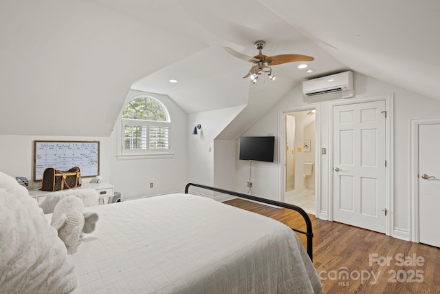 117 Founders Dr, Flat Rock, NC 28731 - bedroom with a wall mounted AC, wood finished floors, lofted ceiling, ceiling fan, and connected bathroom