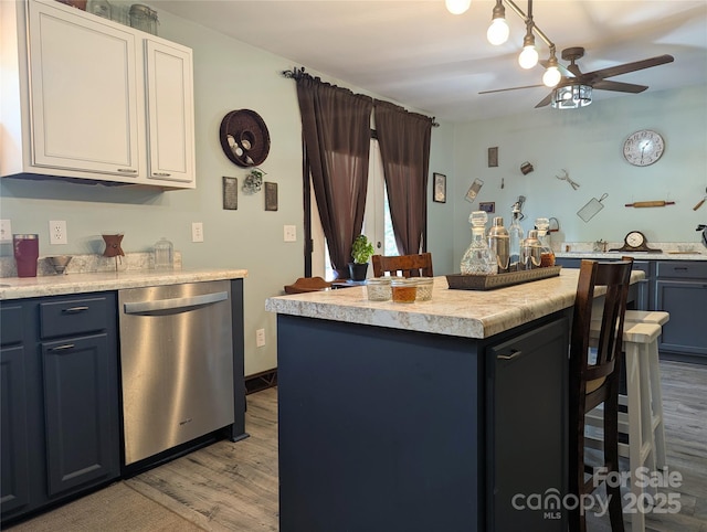 3080 Shue Rd, Salisbury, NC 28147 - kitchen with dishwasher, wood finished floors, ceiling fan, light countertops, and a kitchen island