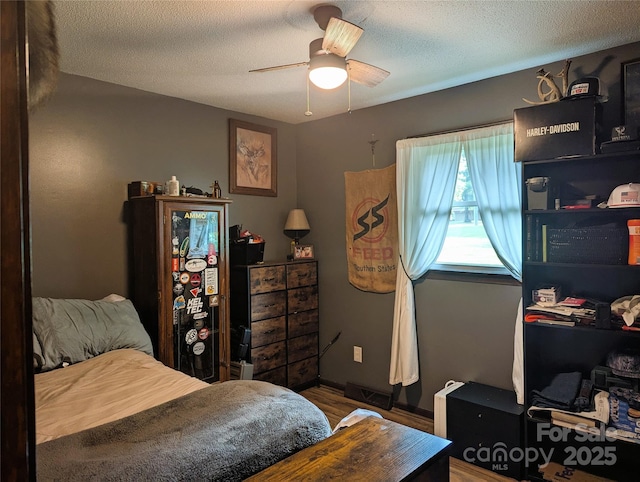 3080 Shue Rd, Salisbury, NC 28147 - bedroom featuring wood finished floors, a textured ceiling, and ceiling fan