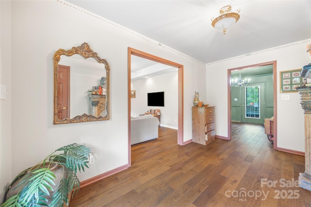 1010 Rainbow Cir, Catawba, SC 29704 - hallway featuring wood finished floors, a chandelier, and crown molding