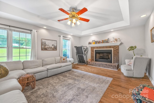 1010 Rainbow Cir, Catawba, SC 29704 - living room with a raised ceiling, wood finished floors, ceiling fan, a fireplace, and recessed lighting