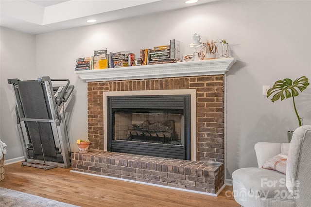 1010 Rainbow Cir, Catawba, SC 29704 - detailed view of a brick fireplace, wood finished floors, and recessed lighting