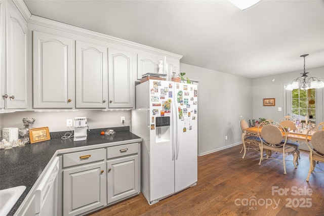 1010 Rainbow Cir, Catawba, SC 29704 - kitchen with white appliances, dark countertops, dark wood-style floors, white cabinetry, and a chandelier