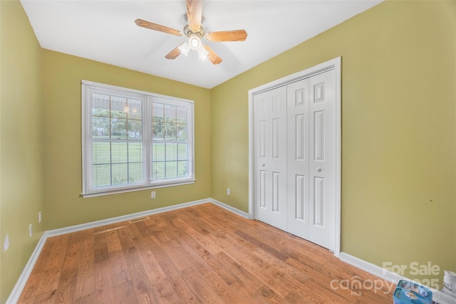 1010 Rainbow Cir, Catawba, SC 29704 - unfurnished bedroom with wood finished floors, a closet, and a ceiling fan