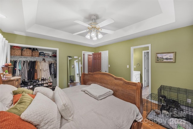 1010 Rainbow Cir, Catawba, SC 29704 - bedroom featuring a tray ceiling, ensuite bath, a closet, and ceiling fan