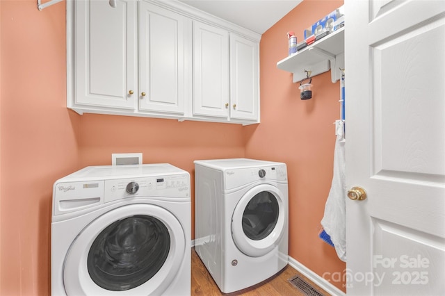 1010 Rainbow Cir, Catawba, SC 29704 - laundry area featuring independent washer and dryer, cabinet space, and light wood-type flooring