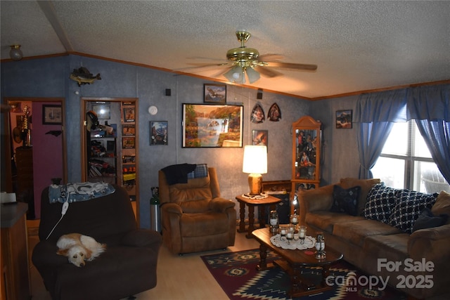 236 Hidden Cove Rd, Marion, NC 28752 - living room featuring ornamental molding, vaulted ceiling, ceiling fan, a textured ceiling, and wood finished floors