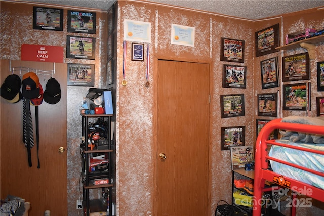 236 Hidden Cove Rd, Marion, NC 28752 - bedroom with a textured ceiling and wallpapered walls