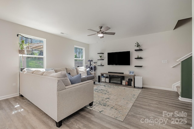 1478 Cannan Mountain Dr, Newton, NC 28658 - living area with wood finished floors, a ceiling fan, and stairway