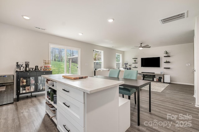 1478 Cannan Mountain Dr, Newton, NC 28658 - kitchen with wood finished floors, white cabinetry, a kitchen island, recessed lighting, and ceiling fan