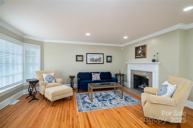 806 S Point Rd, Belmont, NC 28012 - living area featuring plenty of natural light, light wood finished floors, ornamental molding, a premium fireplace, and recessed lighting