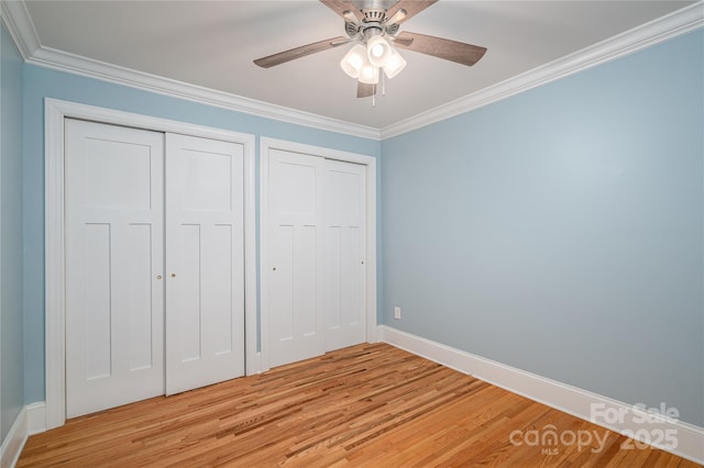 806 S Point Rd, Belmont, NC 28012 - unfurnished bedroom featuring light wood finished floors, crown molding, two closets, and ceiling fan