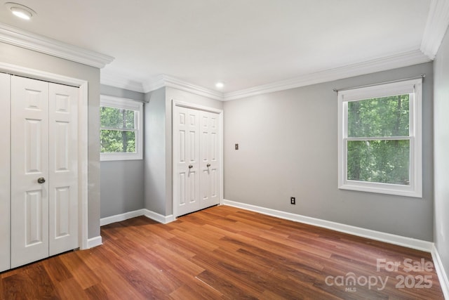 8 Hickory Ridge Ct, Clover, SC 29710 - unfurnished bedroom with two closets, wood finished floors, and ornamental molding